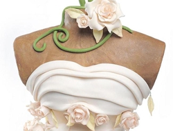 一款艺术造型的婚礼翻糖蛋糕，穿着婚纱的翻糖蛋糕