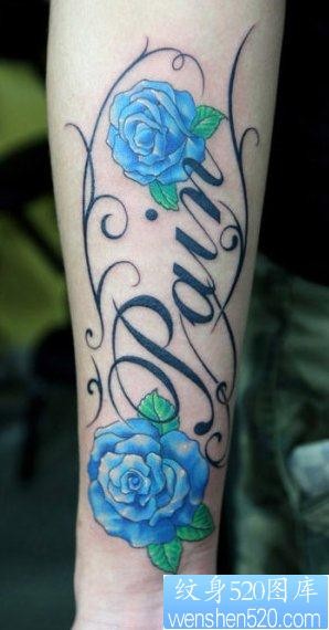 手臂一幅彩色玫瑰花与字母纹身图片