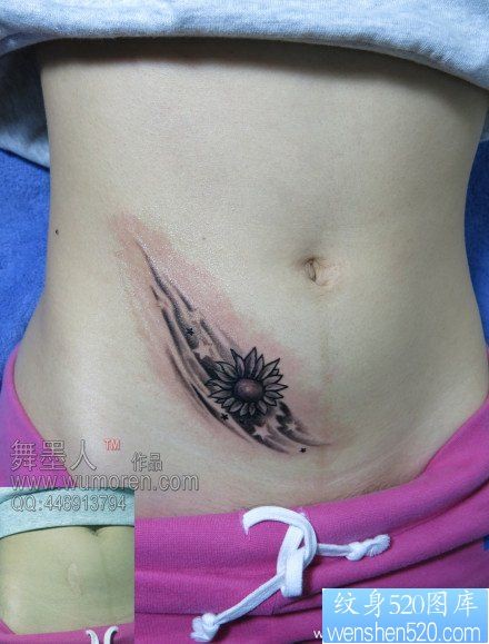 美女腹部小太阳花纹身图片