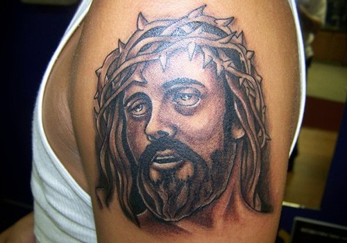手臂上一款个性的耶稣头像纹身