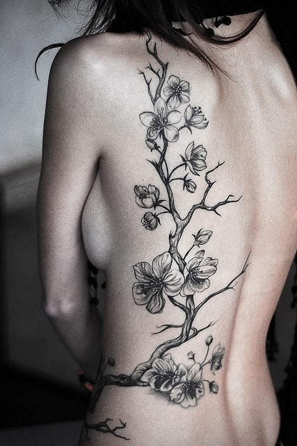 女性背部到腰部的梅花刺青