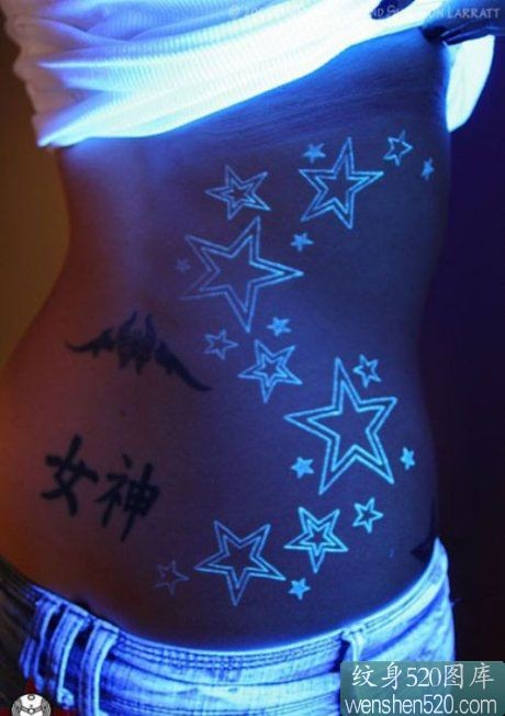 女性腰部的荧光星星图案纹身
