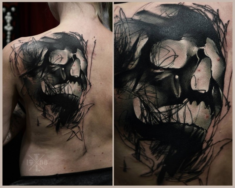背部黑色的恶魔头颅纹身图案