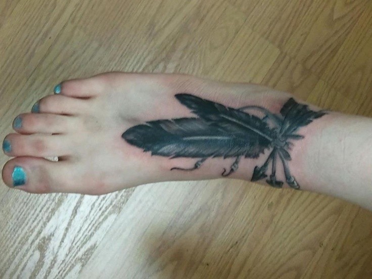 女性脚背箭头和羽毛纹身图案