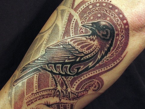 手臂上的小鸟和红色图腾纹身图案