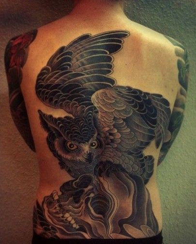背部黑色的猫头鹰和骷髅纹身图案