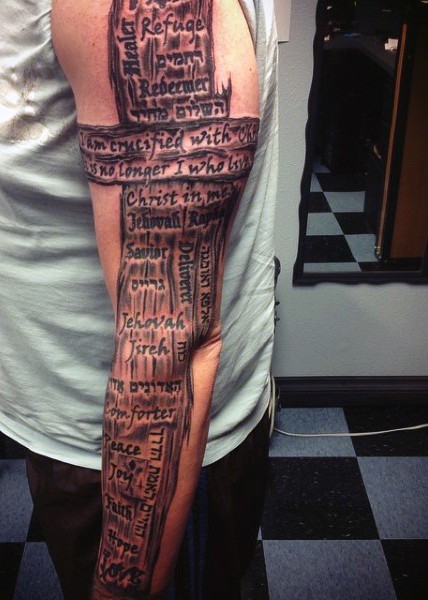手臂木制的十字架和字母纹身图案