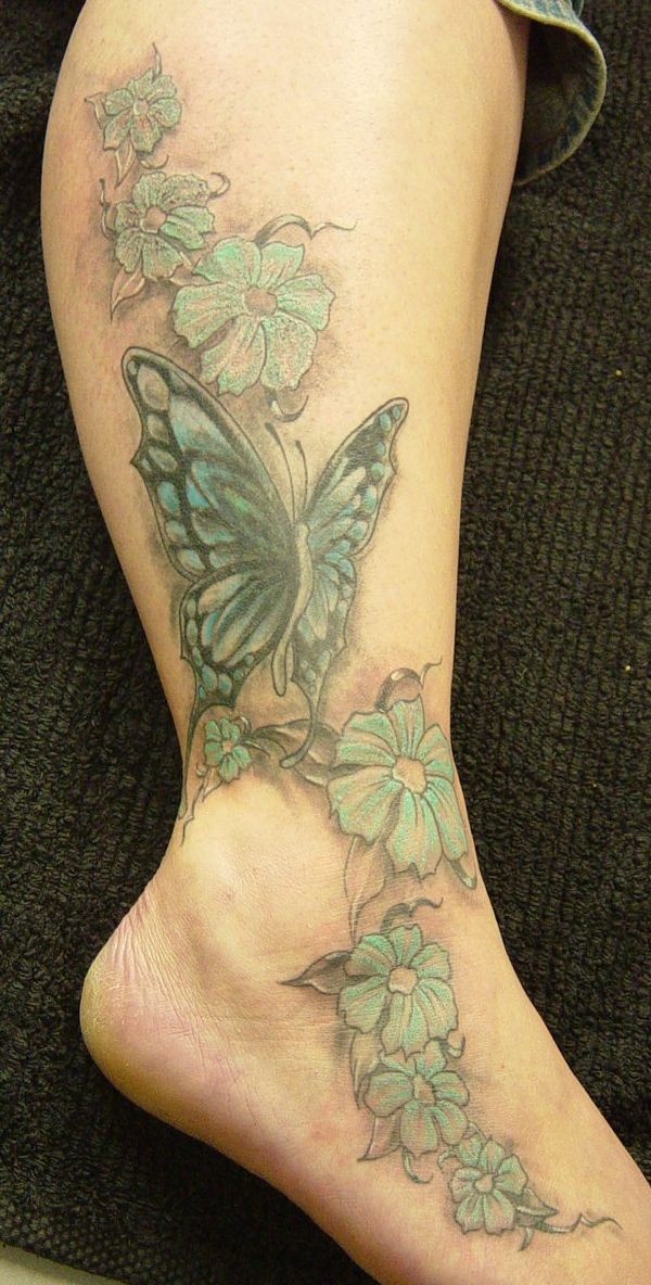 腿部彩色的蝴蝶和花卉纹身图案