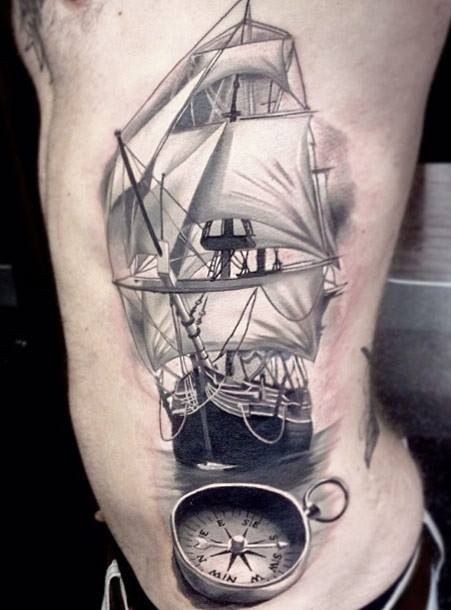 侧肋写实风格的黑白帆船与指南针纹身图案