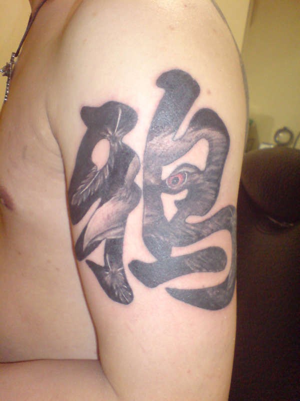 手臂带有汉字和乌鸦的纹身图案
