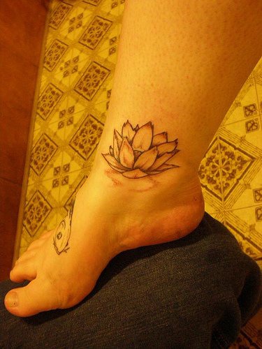 腿上的简约白莲花纹身图案