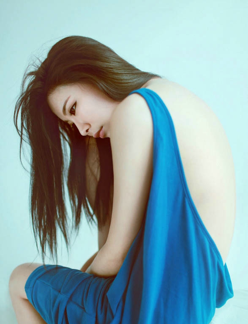美女身穿蓝色宽松露背吊带裙耍性感