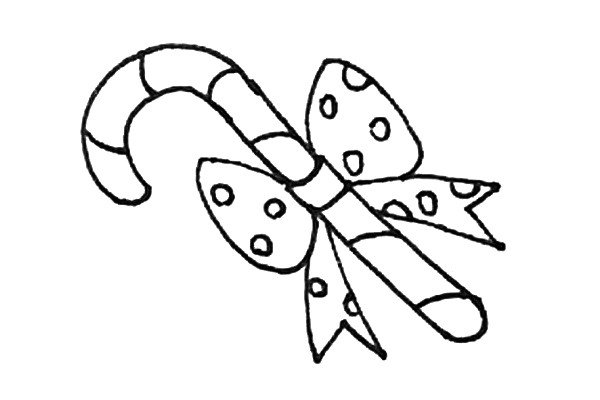 第八步：还需要用弧线给拐杖糖画上纹理，以及在蝴蝶结上画上圆形的装饰。