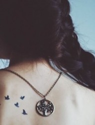 女性背部一群小鸟刺青