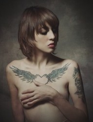 女性胸前羽翼刺青