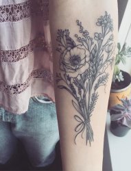 女孩手臂上精致的植物插花纹身图片