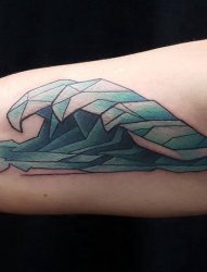 手臂上蓝色的立体几何海浪纹身图片