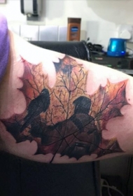 手臂的彩色枫叶和人像纹身图案