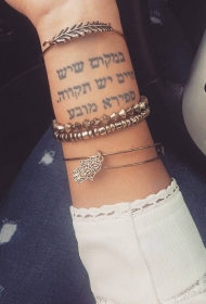 女生手腕黑色的阿拉伯字母纹身图案