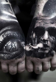 手背黑色的恐怖风格男子肖像与神秘眼睛纹身图案