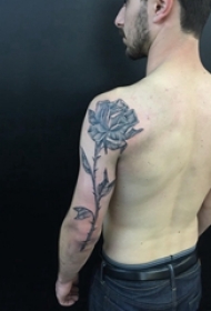 男生大臂上黑色点刺简单抽象线条植物花朵纹身图片